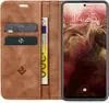 A brown leather flip case for a smartphone, with cards and a banknote inserted. Produktbild-Vorschau