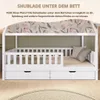 A white wooden house-shaped bed with two drawers underneath, set against a green wall with floral wallpaper. Produktbild-Vorschau