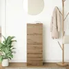 A wooden sideboard with drawers is shown in a room with a plant and a coat rack. Produktbild-Vorschau