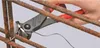 A hand using wire cutters to cut wire around rebar. Anteprima dell’immagine prodotto