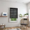 A room with a window fitted with black zebra blinds, a wooden chair, and a small table with a book. Produktbild-Vorschau