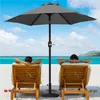 Two people relaxing on lounge chairs on a beach under a gray umbrella. Produktbild-Vorschau