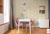 A dining area with a table and chairs, decorated with wall panels. Anteprima dell’immagine prodotto
