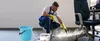 A man is cleaning the floor with a steam cleaner. Náhled obrázku produktu