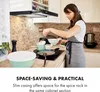 A woman is cooking in a kitchen under a range hood. Podgląd zdjęcia produktu