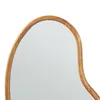 A close-up view of the edge of a mirror with a wooden frame. Anteprima dell’immagine prodotto
