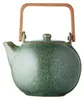 A green ceramic teapot with a wooden handle against a white background. Produktbild-Vorschau