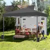 People enjoying a picnic under a canopy in a backyard. Produktbild-Vorschau