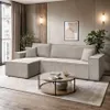 A modern living room with a sectional sofa, coffee table, and plants. Produktbild-Vorschau