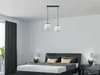 A bedroom scene with a bed, nightstands, and a pendant light fixture. Podgląd zdjęcia produktu