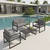 An outdoor lounge set with a coffee table is placed next to a swimming pool in front of a modern house. Anteprima dell’immagine prodotto