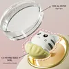 A close-up marketing image showing a customizable doll inside a product, with a clear dome and labels indicating features. Voir les images du produit