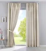 A pair of beige curtains are shown hanging in front of a window with a view of trees and a lawn. Produktbild-Vorschau