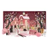 A makeup advent calendar with various makeup products displayed in front of a festive, snowy village scene. Produktbild-Vorschau