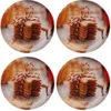 Four round plates, each featuring a stack of star-shaped cookies tied with red and white twine, set against a blurred background of wooden planks and warm lighting. Produktbild-Vorschau