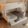 A white bunk bed with stairs and storage drawers, set up in a room. Náhled obrázku produktu