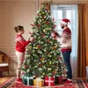 A couple decorating a Christmas tree in a living room. Produktbild-Vorschau