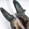 A close-up of a decorative garden water feature shaped like a frog's head, with a clear tube running through it. Produktbild-Vorschau