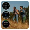 A couple hiking in a grassy field with trees in the background. The image shows multiple smartwatch screens displaying fitness data. Podgląd zdjęcia produktu