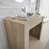 A close-up view of a light brown wooden console table with decorative items on top. Produktbild-Vorschau