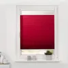A red pleated blind is installed on a window. Produktbild-Vorschau