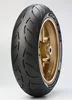 A motorcycle tire mounted on a gold rim, shown against a white background. Náhled obrázku produktu
