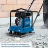 A person is using a blue and black plate compactor on a construction site with a brick wall in the background. Produktbild-Vorschau