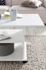 A white coffee table with a book and mug on top, placed on a textured rug next to a sofa. Voir les images du produit