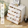 A white dresser with four open drawers filled with various items, placed in a room with a couch and a wooden floor. Anteprima dell’immagine prodotto