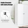 A close-up view of a white storage cabinet with a focus on its safety features, specifically an anti-toppling device. Náhled obrázku produktu