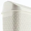 Close-up of the textured surface and lid of a white plastic trash can. Produktbild-Vorschau