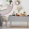 A table set for a meal with a tablecloth, plates, glasses, food, and decorations. Produktbild-Vorschau