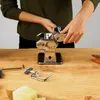 A person's hands are assembling a pasta maker on a wooden table. Anteprima dell’immagine prodotto