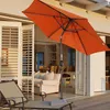 An outdoor patio scene with a lounge chair and an orange umbrella. Voir les images du produit