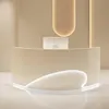 A modern reception desk with a curved front and integrated lighting, set against a neutral background. Produktbild-Vorschau