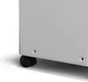 A close-up view of the bottom corner of a white appliance, showing a black wheel and two small holes. Náhled obrázku produktu