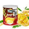 A can of mango puree is shown next to fresh mango slices and leaves, with splashes of liquid. Produktbild-Vorschau