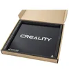 A black glass plate with the 'CREALITY' logo printed on it, placed inside a cardboard box with foam padding. Náhľad obrázku produktu