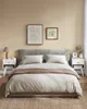 A bedroom scene with a bed, nightstands, and artwork. Náhled obrázku produktu