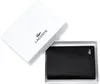 A black Lacoste wallet is presented in its white packaging box, which is open. Anteprima dell’immagine prodotto