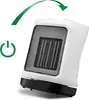 A white and black ceramic heater is shown tilted on a white background. A green power symbol and a green curved arrow indicating oscillation are present. Podgląd zdjęcia produktu