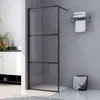 A modern bathroom with a glass shower enclosure, a towel rack, and a laundry basket. Produktbild-Vorschau