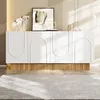 A modern white sideboard with a ribbed wood base, displayed in a well-lit room with decorative items on top. Náhľad obrázku produktu