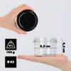 A hand holds a black lid above a glass jar, while another hand holds the jar. Dimensions are shown on the jar. Anteprima dell’immagine prodotto