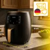 A black and gold air fryer is displayed on a kitchen counter, with dimensions indicated and a promotional graphic in the upper right corner. Produktbild-Vorschau