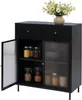 A black sideboard with two drawers and two cabinet doors, one of which is open, revealing jars of food items. A vase of yellow flowers sits on top. Podgląd zdjęcia produktu