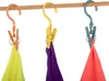 Three clothes clips with hooks hang on a wooden rod, each holding a piece of fabric. Anteprima dell’immagine prodotto