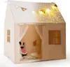 A children's play tent shaped like a house, decorated with string lights and flags, with stuffed animals inside. Podgląd zdjęcia produktu