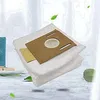 Vacuum cleaner bags on a light-colored surface with a blurred background. Produktbild-Vorschau