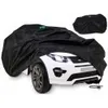 A black car cover is draped over a white toy car. Produktbild-Vorschau